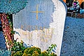 Die Grabstätte des Monheimer Kunstmalers Hans Mayer - aufgelöst im Mai 2017 Grabstein mit der goldener Aufschrift „Kunstmaler Hans Mayer 1901 - 1958“ und einem goldenem Kreuz, umgeben von Pflanzen. Im Hintergrund Schottersteine und weiters Grab.