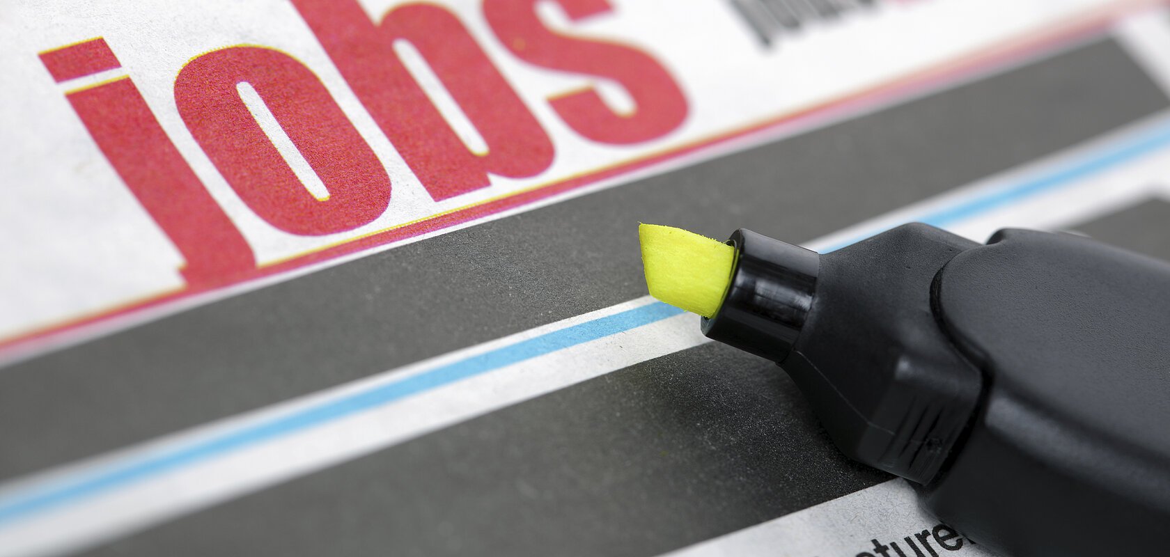 Job listing pages of a newspaper with highlighter pen