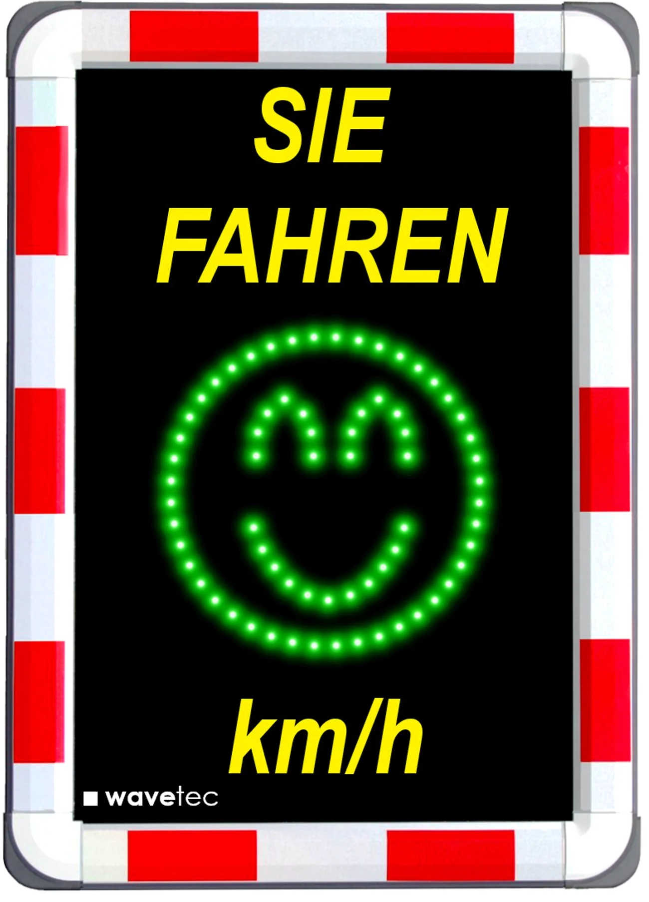 Bild eines Geschwindigkeitsmessgeräts im Straßenverkehr, darauf oben gelber Text "Sie fahren" und unten "km/h". Dazwischen ein grünes Smiley-Gesicht aus LEDs. Der Rand außen ist rot/weiß.