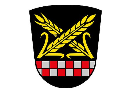 Das Wappen des Monheimer Stadtteils Itzing. Wappen mit zwei gekreuzten goldenen Ähren über einem rot-silbernen Schachbrettmuster auf schwarzem Hintergrund.