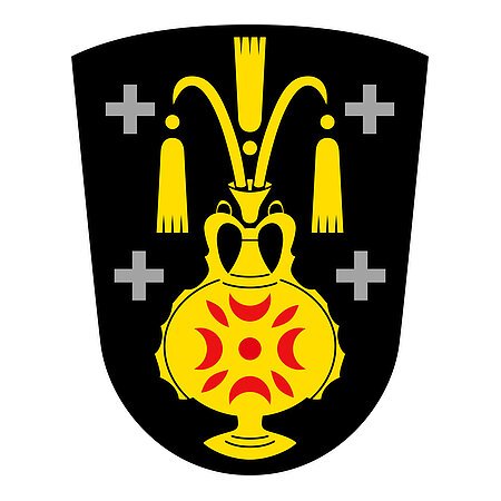 Das Wappen des Monheimer Stadtteils Kölburg: gelber Krug auf schwarzem Hintergrund, auf dem Krug rote Muster. Jeweils links und rechts zwei graue Kreuze.