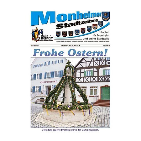 Titelblatt der Monheimer Stadtzeitung vom 17. April 2014 mit der dazugehörigen Überschrift in blau/schwarz, Wappen der Stadt Monheim und der dazugehörigen Stadtteile und mit dem Logo der Stadt Monheim. Auf der Titelseite ein Foto von einem Osterbrunnen in einer gepflasterten Innenstadt mit Fachwerkhäusern im Hintergrund. Der Osterbrunnen ist mit grünen Girlanden aus Zweigen, Ostereiern und gelben lila Bändern geschmückt.