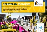Titelseite des Stadtplans der Stadt Monheim, mit dem gleichnamigen Titel auf gelbem Hintergrund, das Wort Stadtplan in blau, das Wort Monheim in weiß. Darunter Angabe aller dazugehöriger Stadtteile von Monheim in schwarzer Schrift und rechts oben im Eck das Logo der Stadt Monheim. Auf dem darunterliegenden Foto der Blick auf historische Fachwerkhäuser in der Monheimer Innenstadt und im Vordergrund unscharf blühende pinke Blumen.