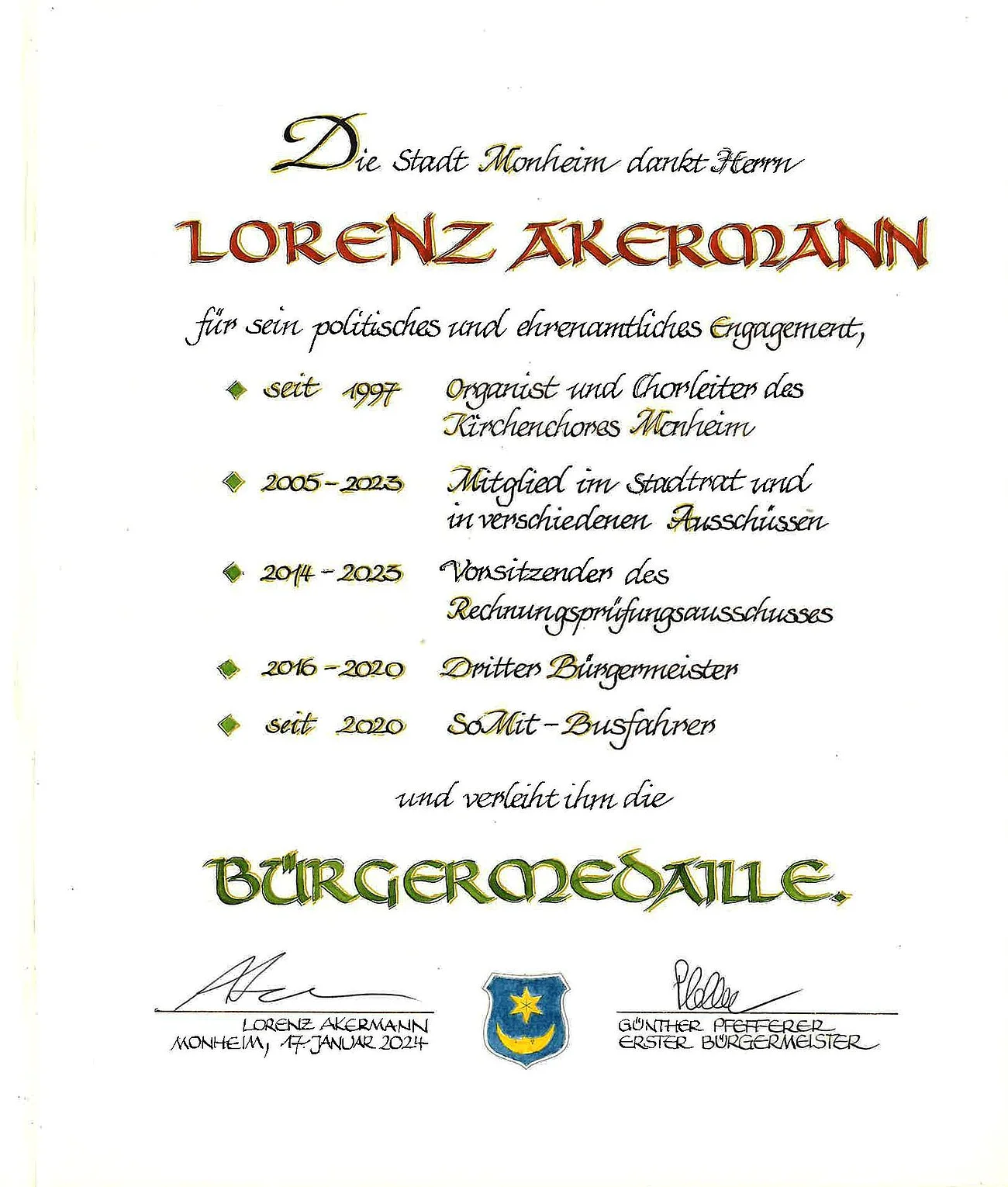 Lorenz Akermann Bürgermedaille Verleihung am 17. Januar 2024 Urkunde der Stadt Monheim für Lorenz Akermann mit mit Aufzählung der Tätigkeiten und Verleihung der Bürgermedaille, darunter zwei Unterschriften und ein Wappen der Stadt Monheim. Datiert 17. Januar 2024.