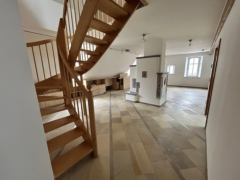 Maisonetten Wohnung Marktplatz 11 Monheim Mietobjekt Maisonetten Wohnung Marktplatz 11, Monheim.
Offener Raum mit Holztreppe, Fliesenboden, weißen Wänden und zwei Fenstern in einer Dachgeschosswohnung